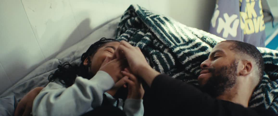 Man lying down with his daughter playing