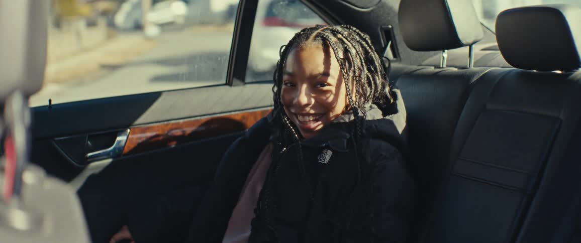 Girl playing in the back seat of a vehicle