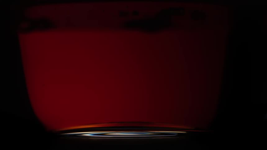 Amber liquid being poured into a glass mug