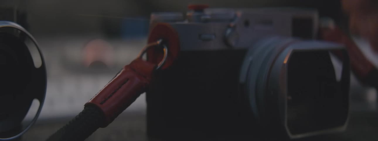 Hand adjusting a camera on top of a surface