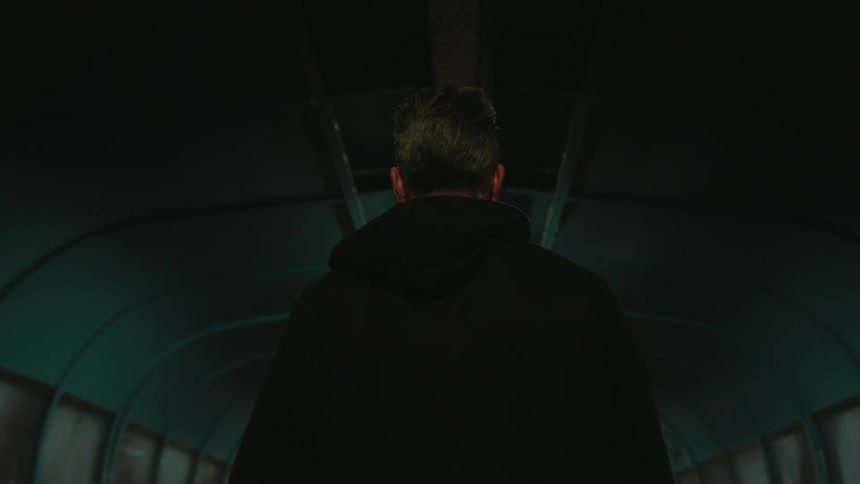 View of a man from behind walking in the corridor of a terminal