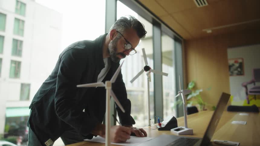 A man is writing in the conference room