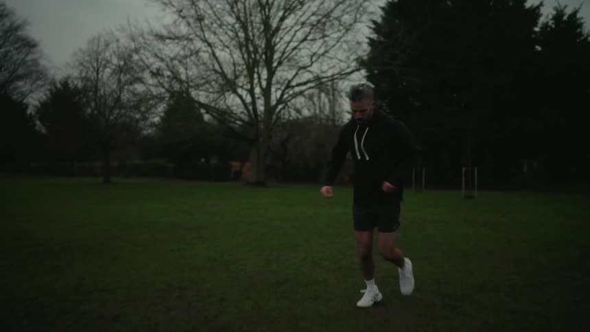 Man jogging outdoors in a grassland area
