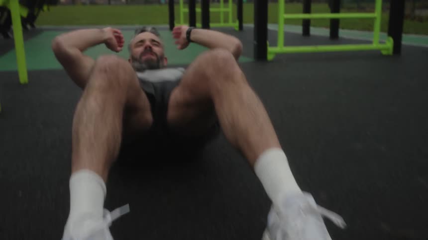 Man in an outdoor gym doing situps
