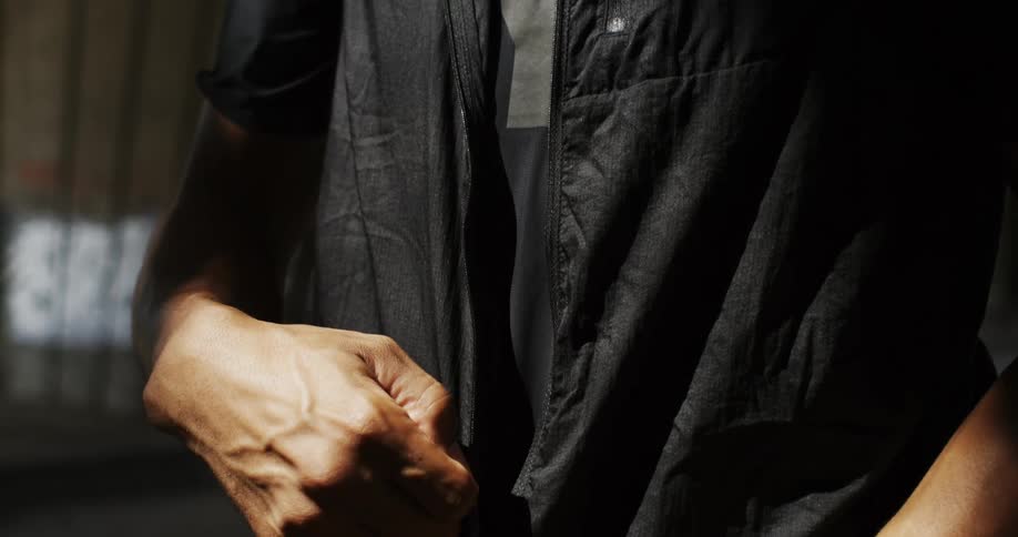Hand closing the zipper of a jacket