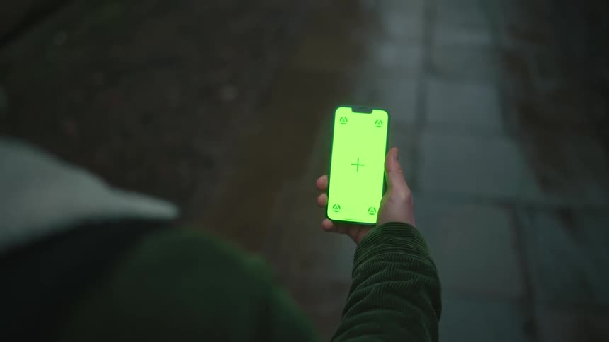 Man walking with active smartphone screen in front of him