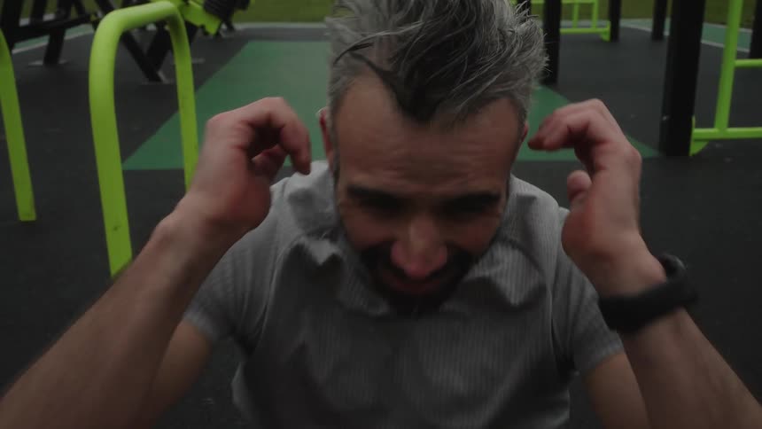 A man is exercising by himself in an indoor gym