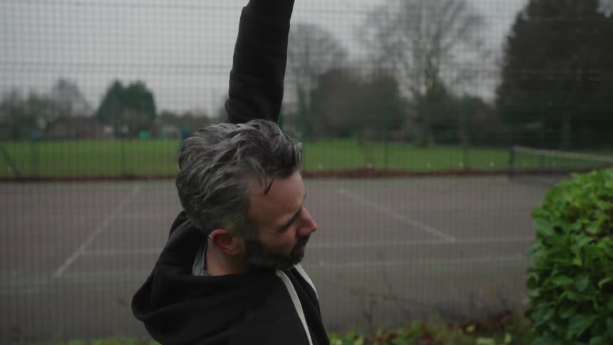 Man outdoors stretching his body