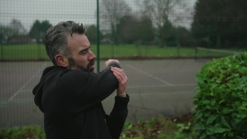 A man is stretching in the park
