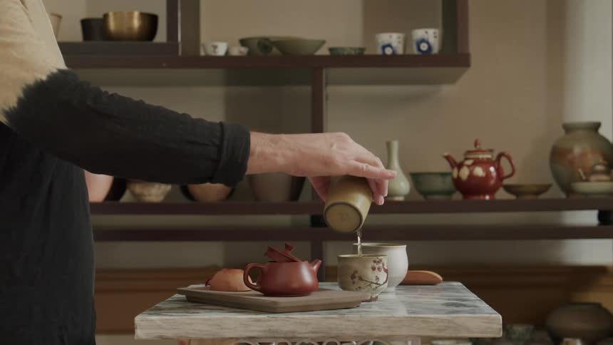 Pair of hands preparing a tea alchemy