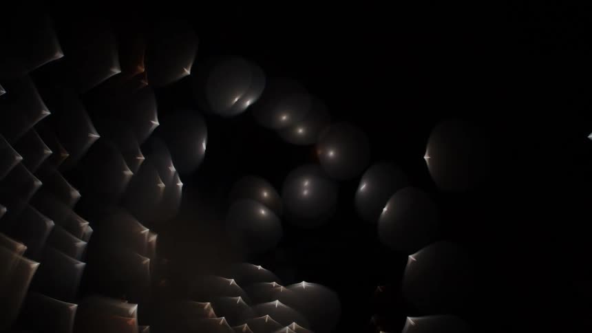 Outoffocus fireworks shoot upward in a fisheye perspective creating an explosion of sparks against the night sky
