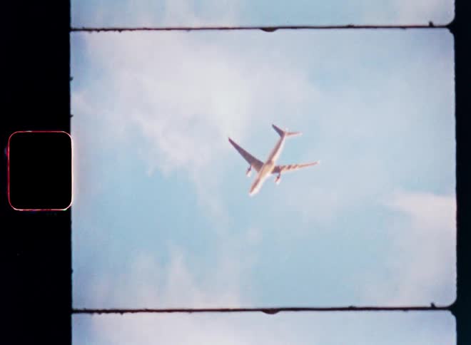 A passenger plane flying in the sky on a cloudy day