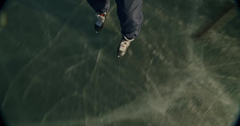Person sliding on an ice rink playing hockey