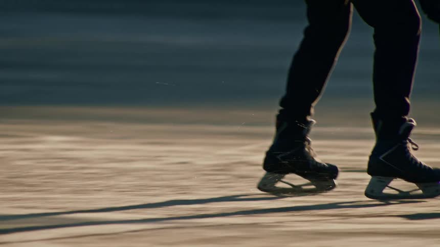 Person with a stick sliding on a hockey rink