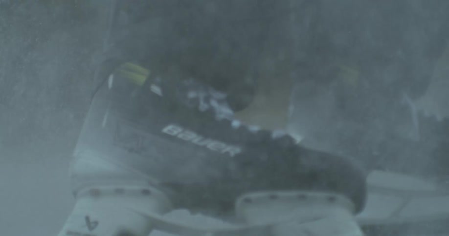 Feet with skates sliding on the ice