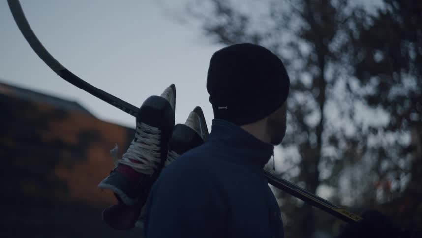 Man in black cap with hockey equipment
