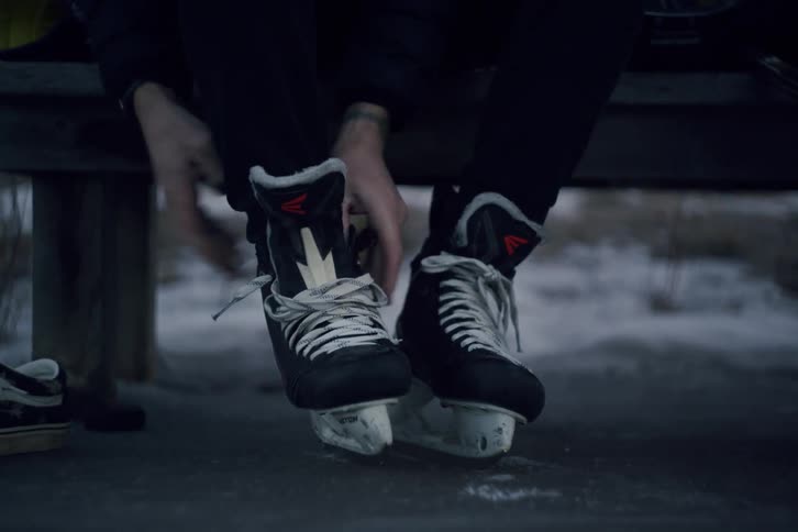 Person tying hockey skates before going on the ice