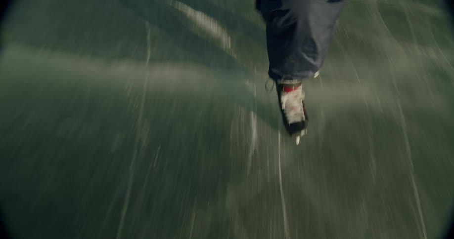 Skater glides quickly across the ice captured from a dynamic perspective