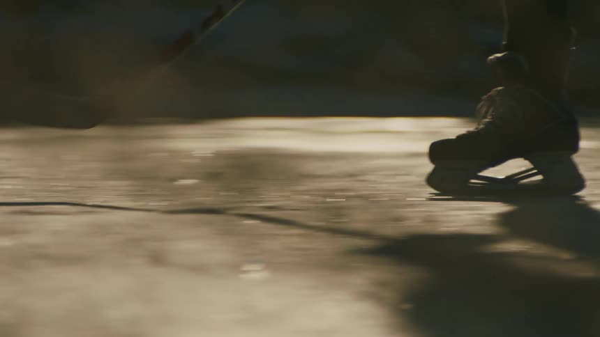 Legs of two people playing a game of hockey