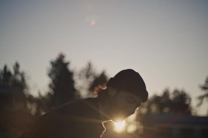 A man wearing a black beanie stands ready to play on a frozen morning