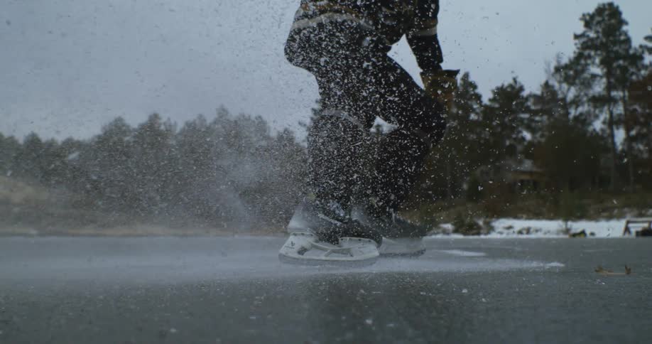 A man slides on the frozen lake on ice skates