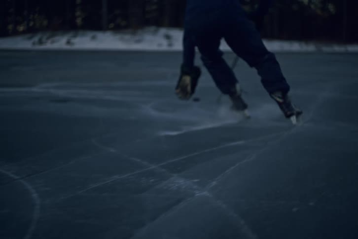 A player slides the puck along the ice