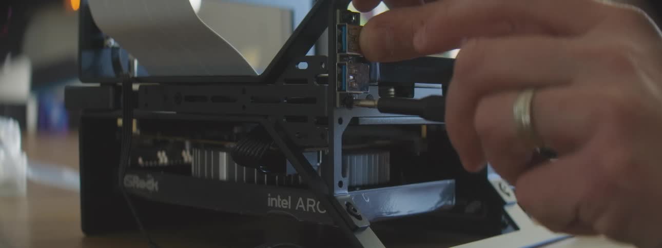 Pair of hands connecting cables and assembling a component