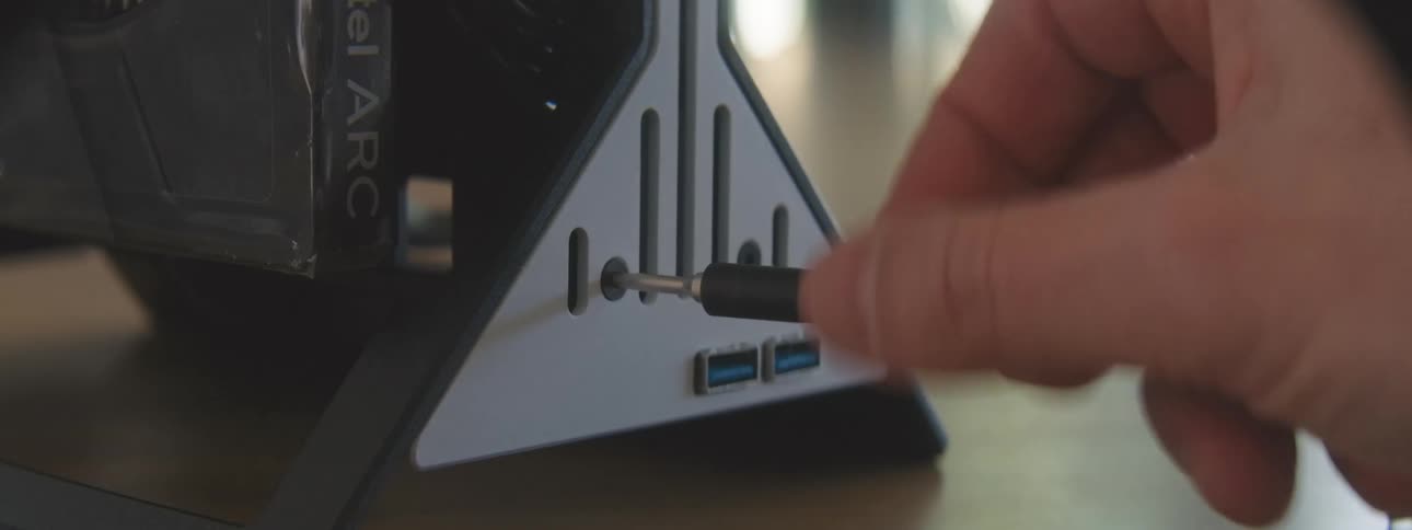 Hand with a screwdriver screwing a device