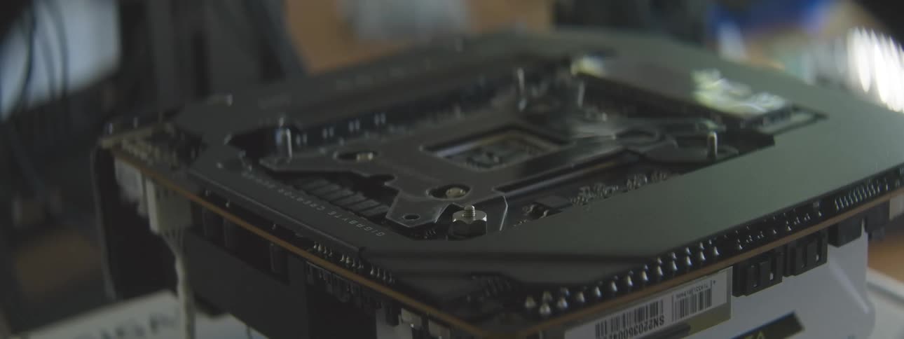 Person adjusts a component on the motherboard during the assembly of a computer