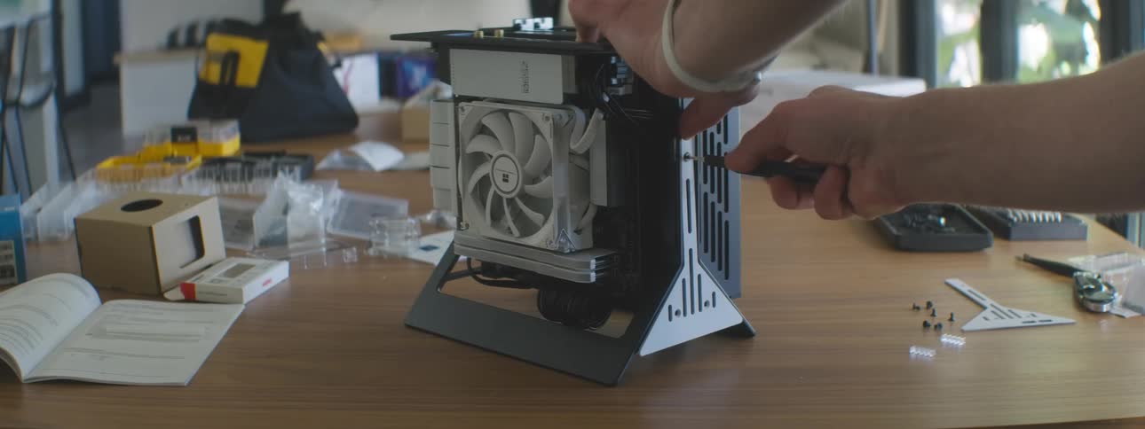 Pair of hands finishing the assembly of a case with components