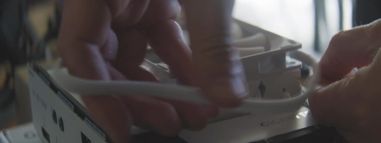 Cable being placed on a computer fan