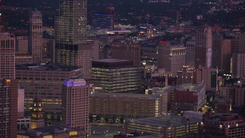 Aerial view of a city at night with illuminated skyscrapers and busy streets