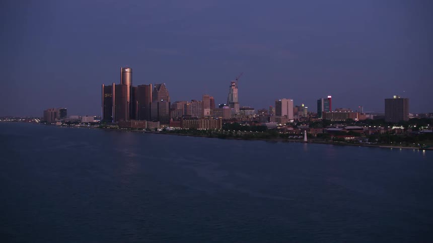 Panoramic view of a riverside city at dusk