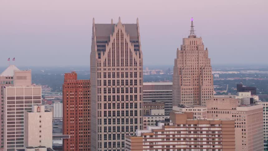 An aerial view shows the detroit skyline at dusk highlighting the guardian building and the penobscot building