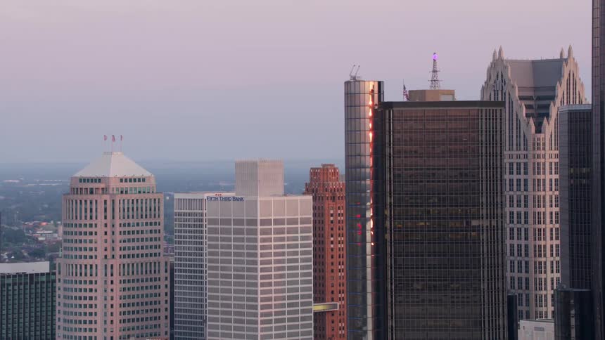 Mirrored skyscrapers reflect the soft evening light across the city