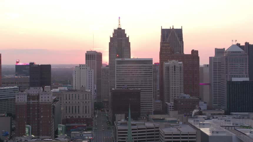 Aerial panorama of skyscrapers in a metropolis with the red sun on the horizon