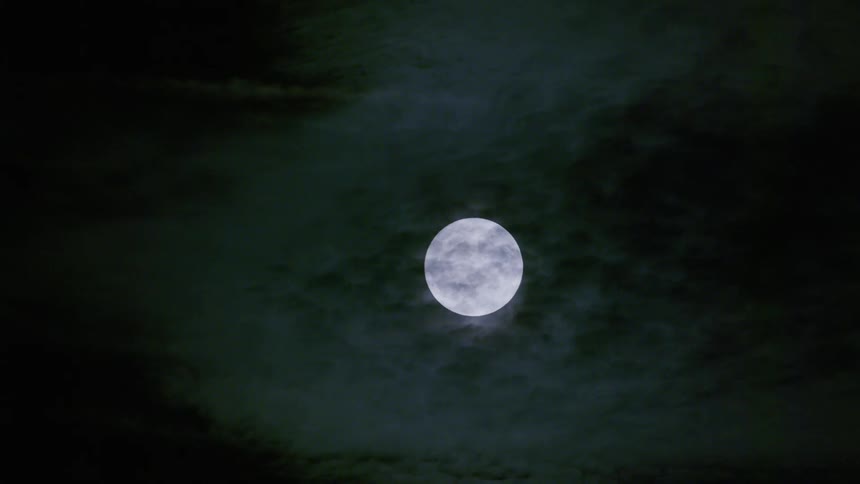 The full moon glows in the sky