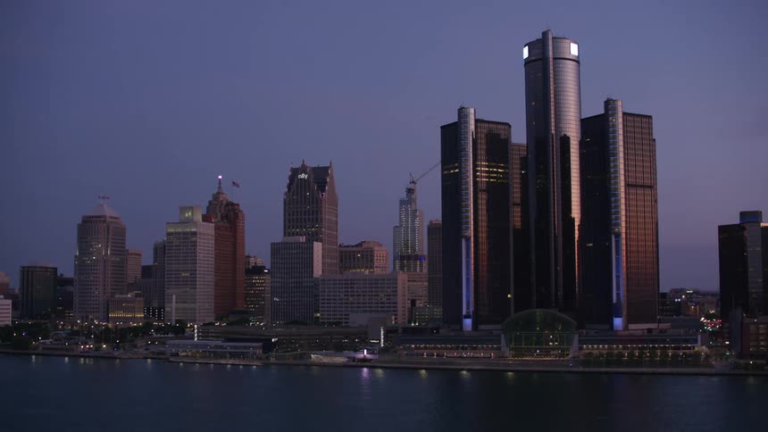 Water reflects the waterfront lights near the downtown skyscrapers