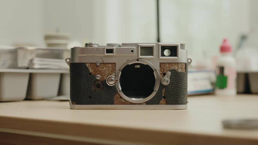 Vintage camera without lens on top of a surface