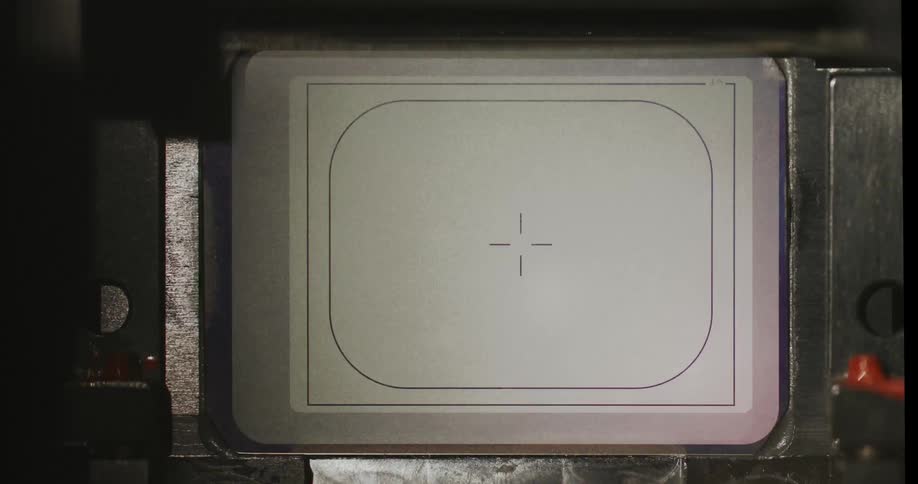 Internal viewfinder of an analog camera showing the focusing screen with framing markings