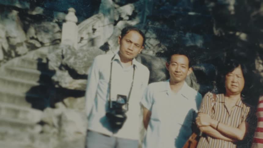 Old photograph shows four people posing together outdoors