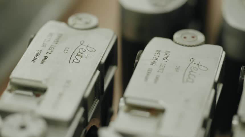 Vintage leica cameras are lined up in closeup