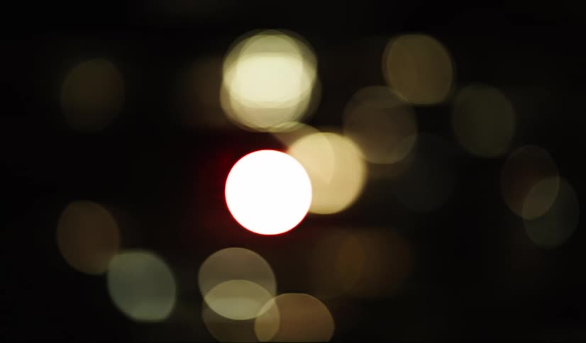 Some blurred circular lights in a dark environment