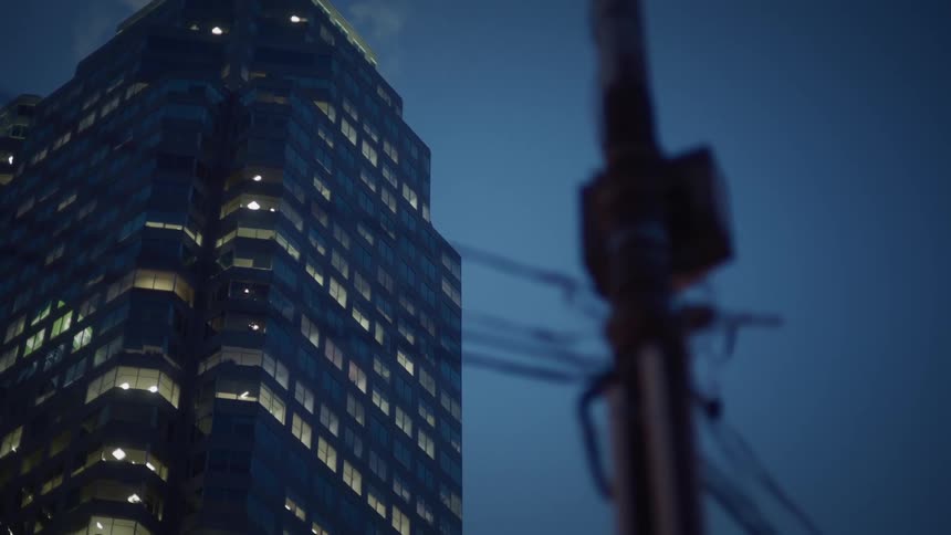 The sun is setting on the tall building