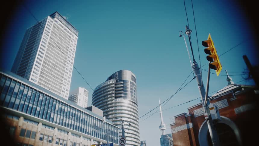 Traffic light in the foreground and buildings of a metropolis in the background