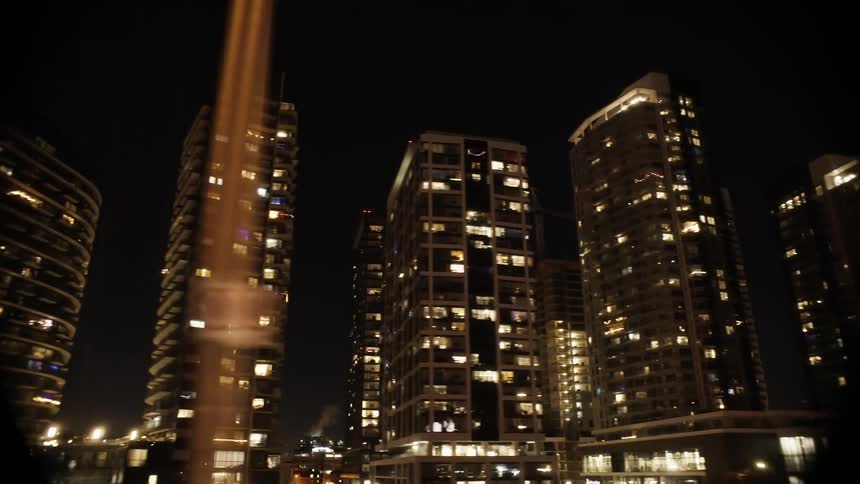 Buildings lit up at night in a metropolis