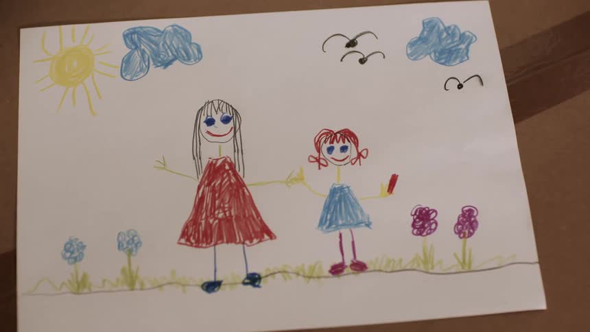 Childs art drawing of mom and daughters standing outdoors on a sunny day
