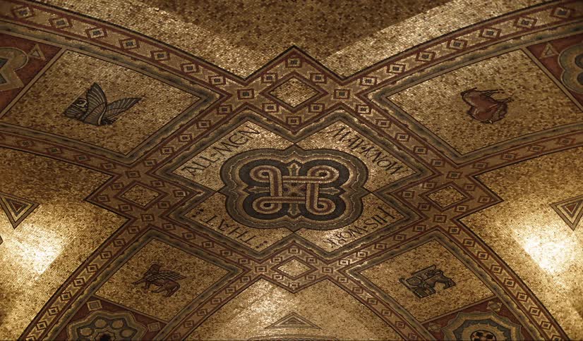 Intricate gold tone dome ceiling design with animals and symbols