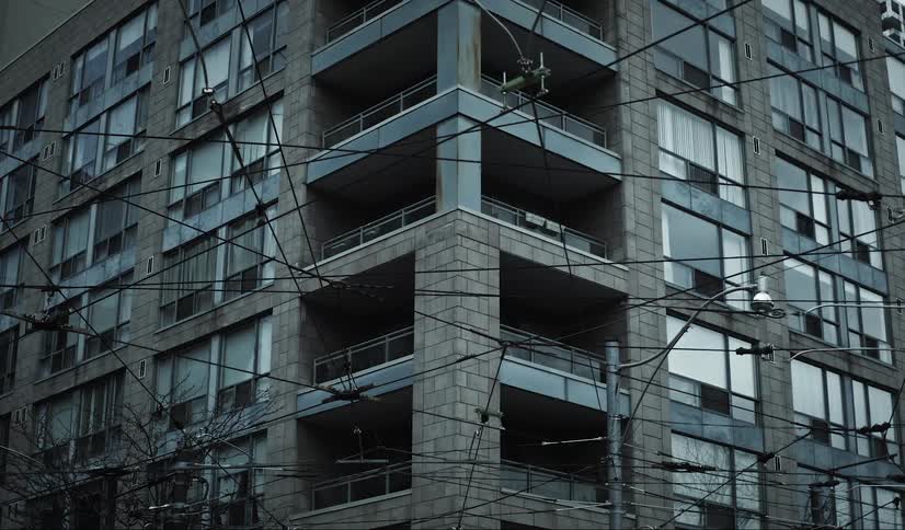 Power lines next to an urban building
