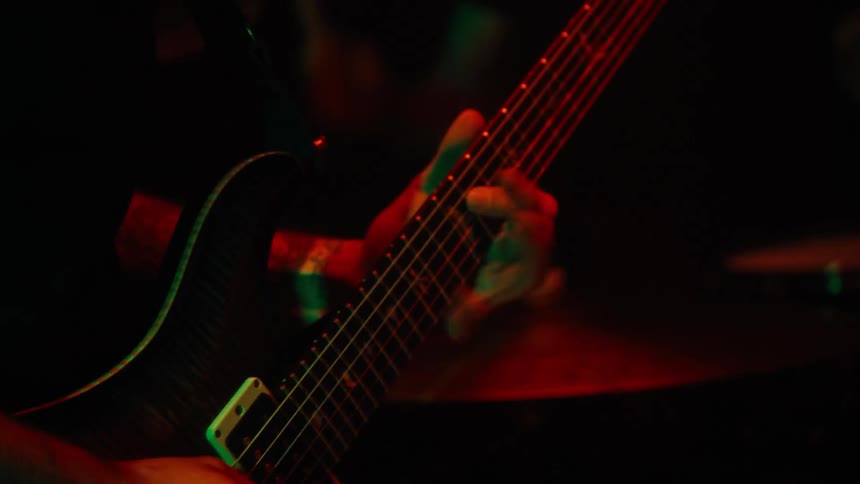 Person playing guitar in a performance